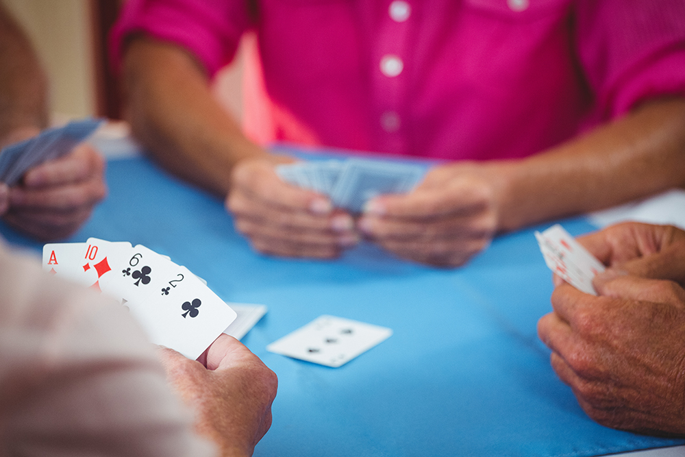 Older group of people playing cards
